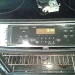Starting to remove the oven's control panel.