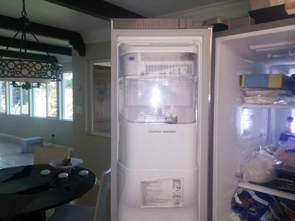 To begin the repair we must remove the non-working ice maker from the refrigerator's door.